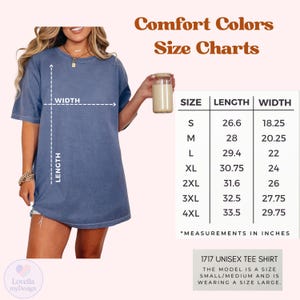 May include: A blue Comfort Colors unisex tee shirt with a size chart. The chart shows measurements in inches for sizes S to 4XL. The model is wearing a size large. The text "Comfort Colors Size Charts" is at the top.