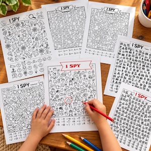 May include: A collection of six black and white I Spy activity sheets featuring various themes including numbers, alphabets, trains, and Valentine's Day. Each page contains a grid of small line-art illustrations with a corresponding checklist below.