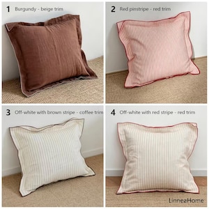 May include: Four decorative throw pillows with different designs. The first is burgundy with a beige trim. The second is red pinstripe with a red trim. The third is off-white with brown stripes and a coffee trim. The fourth is off-white with red stripes and a red trim.