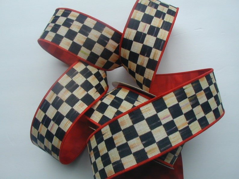 May include: Black and white checkered ribbon with a red edge. The ribbon is made of a woven fabric and has a subtle sheen.