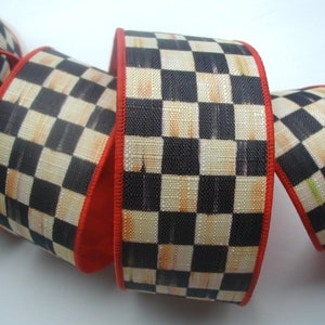 May include: Black and cream checkered ribbon with a red edge. The ribbon is woven with a textured pattern.