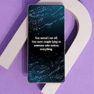 May include: A smartphone displays a dark background with blue and teal speckles and the text: "You weren't cut off. You were caught lying to someone who notices everything." The phone rests on a white, curved object against a purple background.