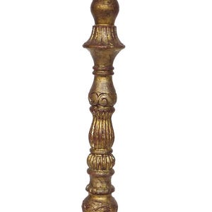May include: A gold-colored table lamp with a white lampshade. The lamp has a detailed, ornate design on the base and stem. The lampshade is a classic tapered shape.