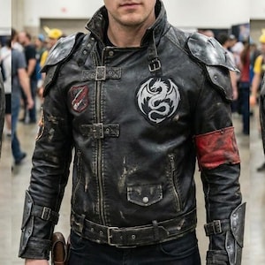 May include: Black leather jacket with metal shoulder and arm armor. The jacket features multiple patches with dragon and crest designs, a red armband, and a buckle belt. The jacket has a distressed look.