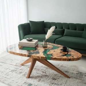 “Handmade olive wood and emerald epoxy coffee table with wooden legs – modern live edge design”