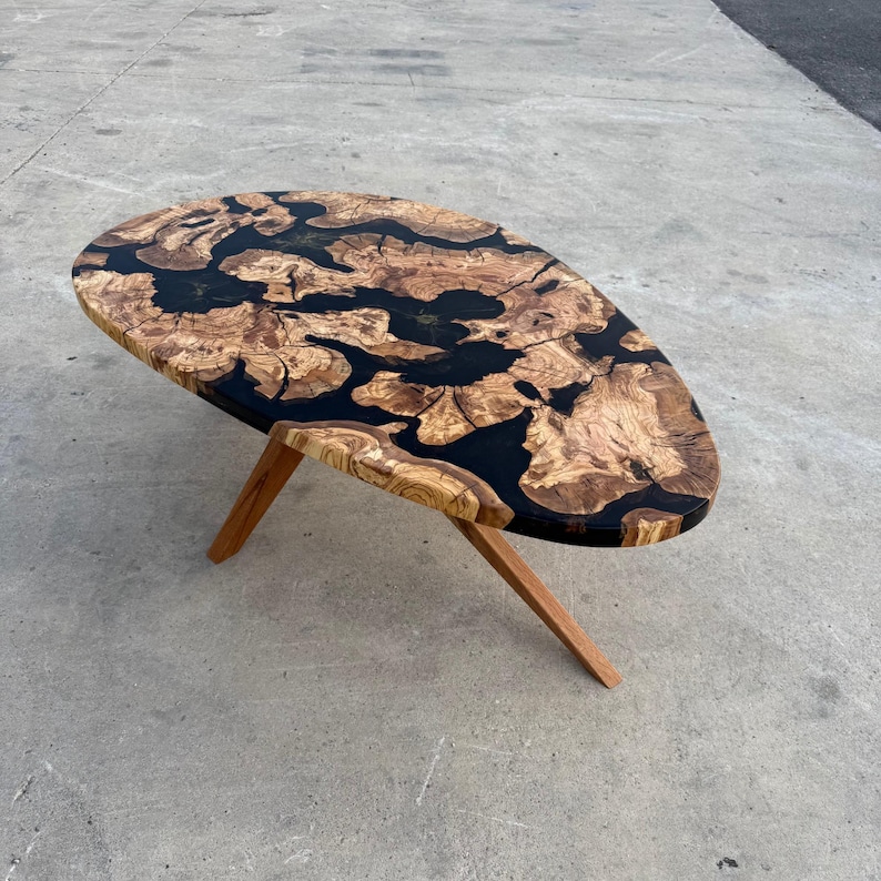 Olive wood surface with clear epoxy river — handcrafted centerpiece table