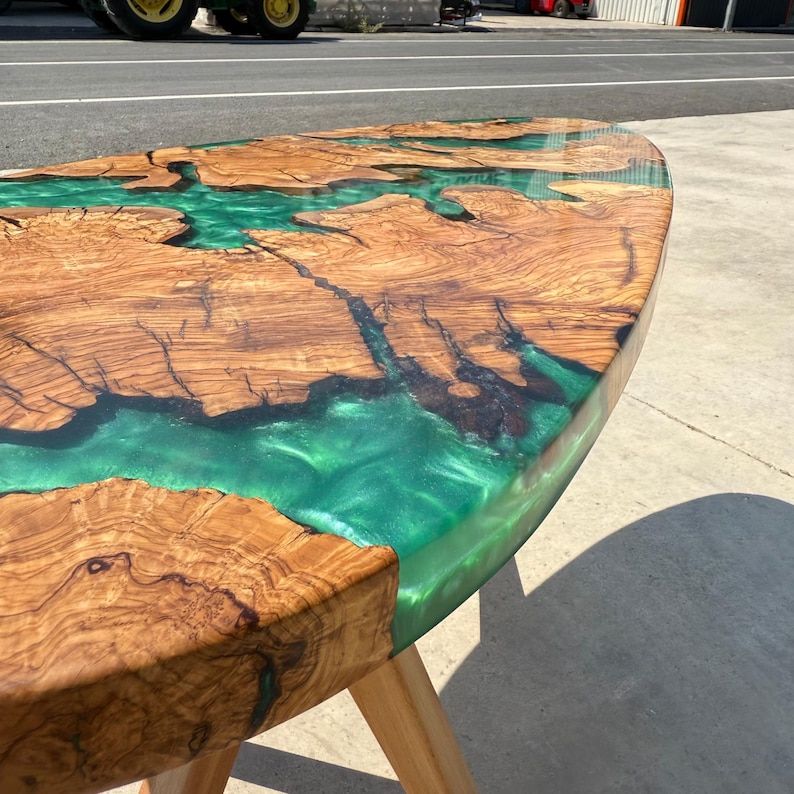 “Large oval olive wood epoxy center table in sunlight – custom made solid wood furniture”