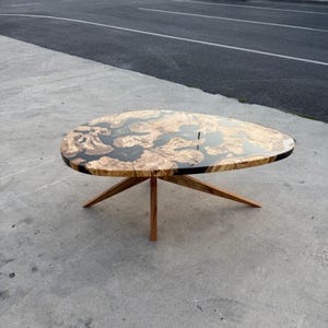 Glossy epoxy resin showing natural olive wood texture and grain