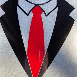 May include: A black tuxedo graphic with a red tie, white collar, and black lapels. The design is a stylized representation of formal wear, suitable for various applications.