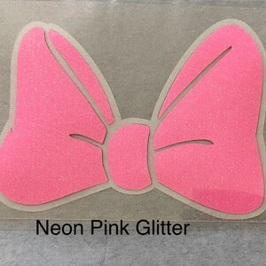 May include: A neon pink glitter bow with a white outline.  The bow is on a clear sheet with the text "Neon Pink Glitter" below it.
