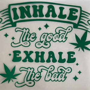 May include: Green and white graphic design with the text "Inhale the good, exhale the bad" and stylized marijuana leaves.