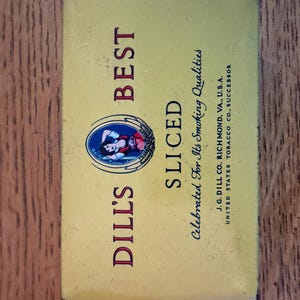 May include: A rectangular yellow metal tobacco tin featuring the text DILL'S BEST SLICED and Celebrated For Its Smoking Qualities. It includes a circular graphic of a person and the text J.G. DILL CO. RICHMOND, VA., U.S.A. UNITED STATES TOBACCO CO., SUCCESSOR.