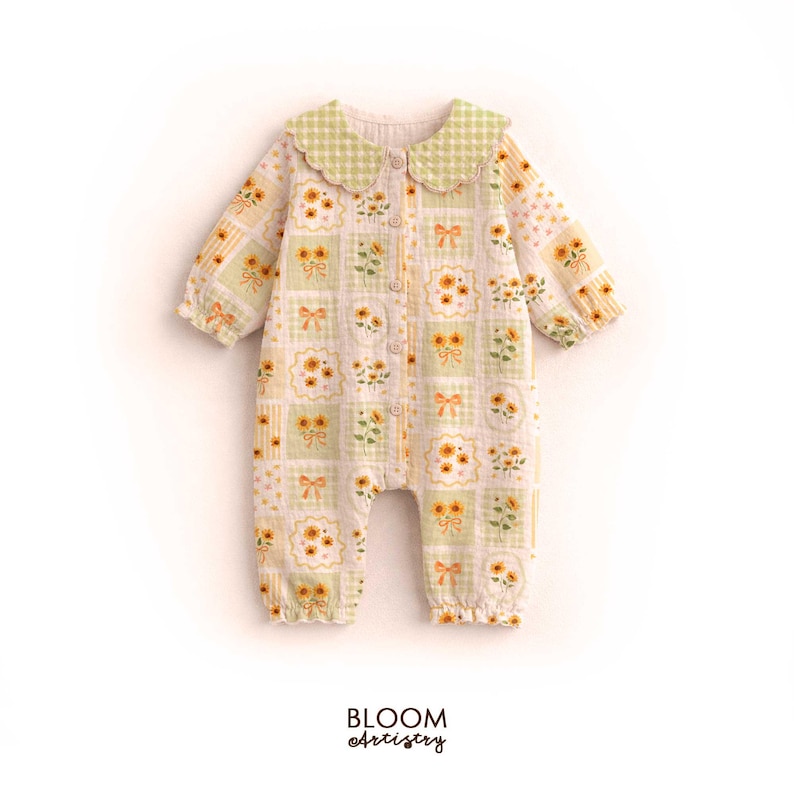 May include: A baby's romper with a floral and bow pattern in yellow, green, and white. The romper has long sleeves, a rounded collar with a green gingham pattern, and the text "BLOOM Artistry" at the bottom.