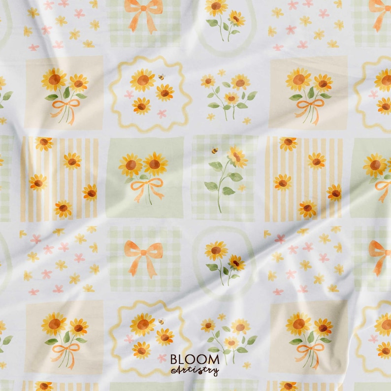 May include: A white fabric with a repeating pattern of watercolor sunflowers, bows, and bees. The design is arranged in a grid of squares with stripes, gingham, and floral backgrounds. The text "BLOOM artistry" is visible.