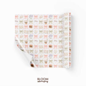 May include: A roll of patterned paper with a repeating design of books, bows, lavender, eyeglasses, and teacups in soft pastel colors. The paper is white with a floral and bookish theme. The text "BLOOM artistry" is at the bottom.