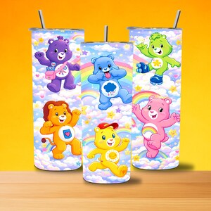May include: Care Bears-themed tumblers with vibrant designs set against rainbows and clouds. Each tumbler showcases a different Care Bear character, complete with a straw and lid. The cylindrical tumblers are likely made of stainless steel.