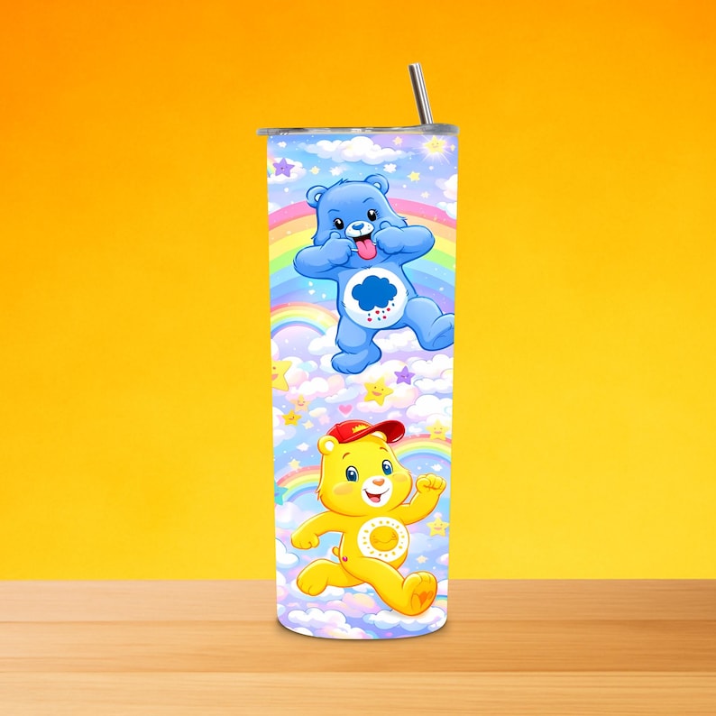 May include: A tall, stainless steel tumbler with a design of two cartoon bears set against rainbows, clouds, and stars. One bear is blue, sticking out its tongue, and the other is yellow, wearing a red cap. The tumbler has a silver straw.