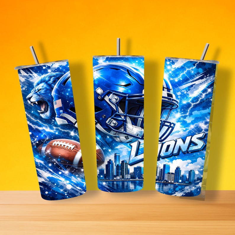 May include: Three stainless steel tumblers with lids and straws. Each tumbler features a blue and white design with a football theme. One tumbler has a lion graphic, another a football helmet, and the third has the word "Lions".