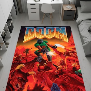 May include: A rectangular area rug featuring the DOOM video game cover art. The rug depicts a green-armored character battling red demons in a fiery landscape. The word "DOOM" is prominently displayed in a gold and blue font.