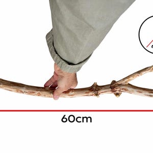 May include: A wooden mallet with a natural branch handle, approximately 23.6 inches long, and a head that is 0.79 to 1.38 inches in diameter. The mallet is held by a person.