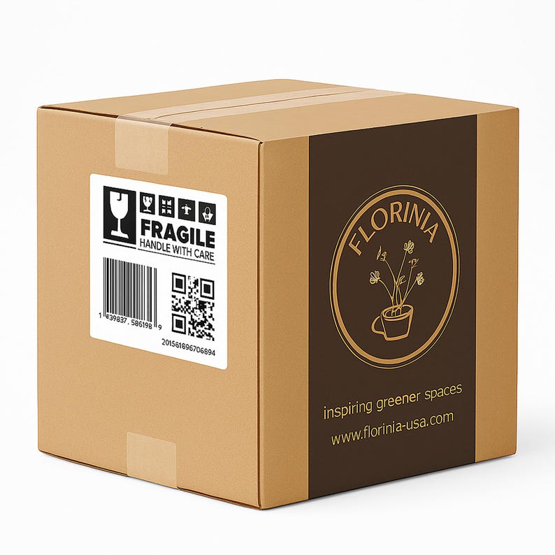 May include: A brown cardboard box with a white label that says "FRAGILE HANDLE WITH CARE". The box has a brown vertical stripe with the Florinia logo and the text "inspiring greener spaces".