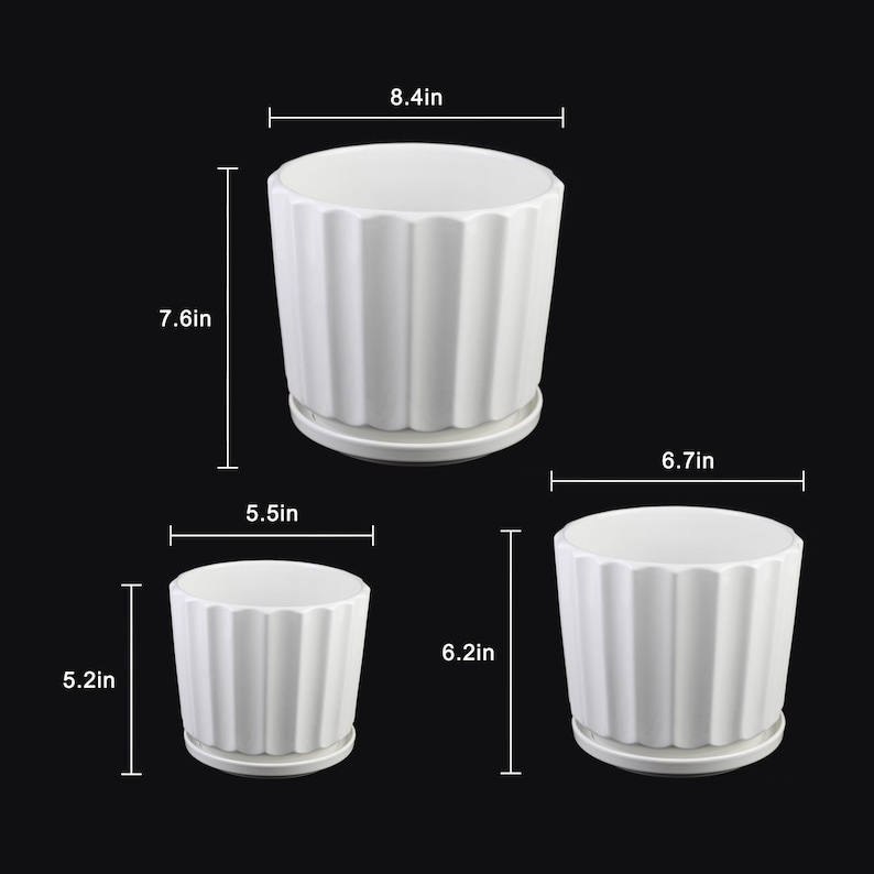 May include: Three white ceramic plant pots with a ribbed design and attached saucers. The largest pot is 8.4 inches wide and 7.6 inches tall. The medium pot is 6.7 inches wide and 6.2 inches tall. The smallest pot is 5.5 inches wide and 5.2 inches tall.