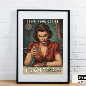 May include: Framed vintage-style print featuring a woman in a red dress holding a cocktail glass. The print includes the text "SHOVE YOUR COFFEE" and "IT'S GIN O'CLOCK." The artwork has a retro aesthetic, with a clock in the background.