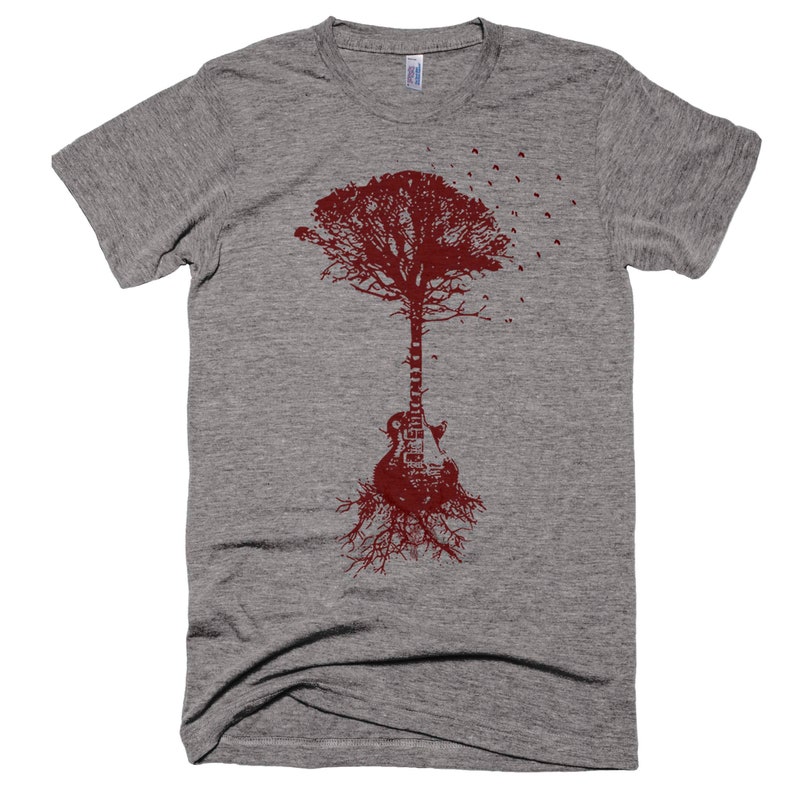 May include: A gray t-shirt with a red graphic of a tree growing out of a guitar. The tree has branches and leaves, and the guitar has a body and neck. Birds are flying away from the tree.