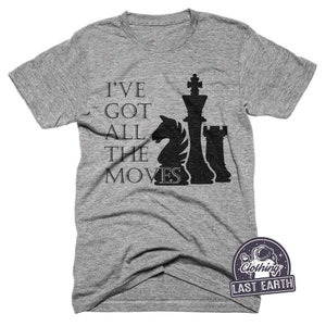 May include: A heather grey t-shirt with a black chess piece graphic and the text "I've got all the moves".