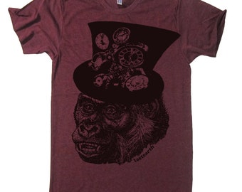 May include: A maroon t-shirt with a black and white graphic print of a gorilla wearing a top hat with gears and clock faces. The text "lastearth" is printed on the bottom right of the graphic.