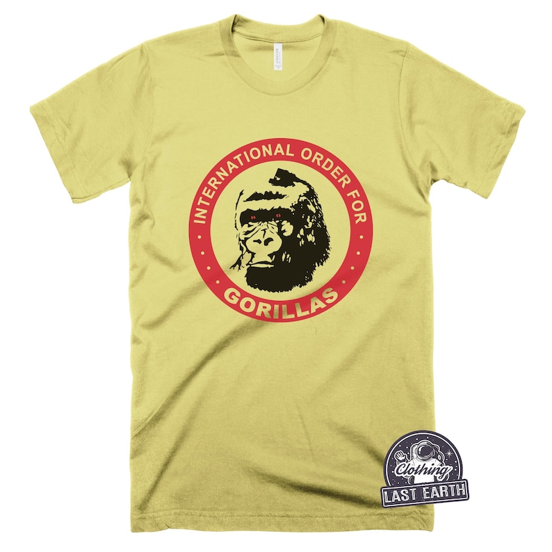 May include: A yellow t-shirt with a red circle and the text "International Order for Gorillas" in red. A black and white gorilla with red eyes is inside the circle.