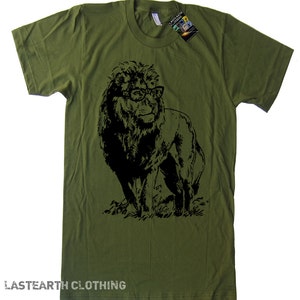 May include: A green t-shirt featuring a black silhouette of a lion wearing glasses. The text "LASTEARTH CLOTHING" is printed on the bottom of the shirt.