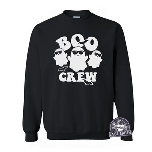 May include: Black sweatshirt with a white graphic of three ghosts wearing sunglasses and the text "BOO CREW".