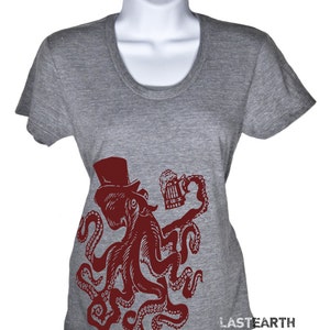 May include: A gray t-shirt with a red octopus wearing a top hat and holding a beer mug. The octopus is in a vintage style illustration. The text "LASTEARTH" is printed on the bottom right corner of the shirt.