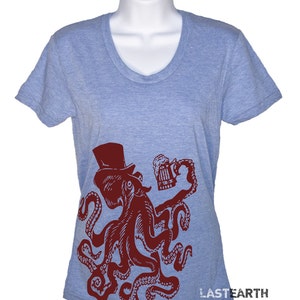May include: A light blue t-shirt with a red octopus wearing a top hat and holding a beer mug. The octopus is in a vintage style illustration. The text "LASTEARTH" is on the bottom right corner of the shirt.