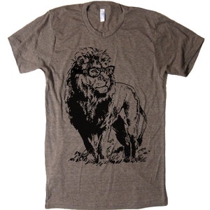 May include: A heather grey t-shirt featuring a black and white graphic of a lion wearing glasses.