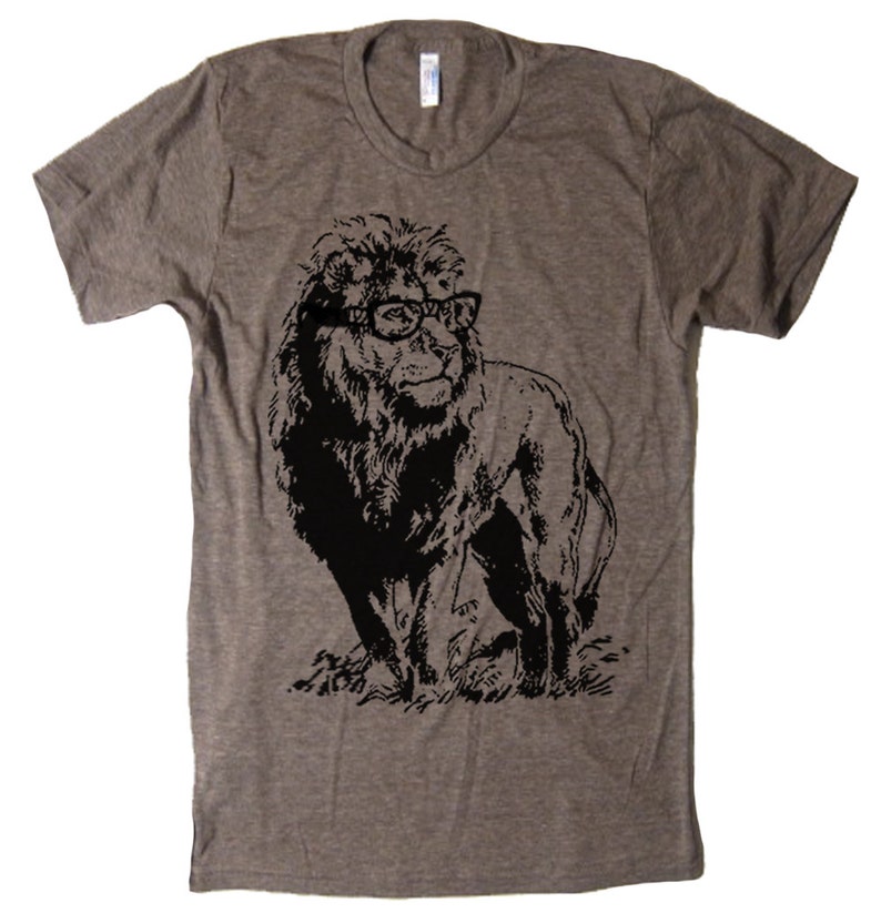 May include: A heather grey t-shirt featuring a black and white graphic of a lion wearing glasses.