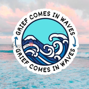 May include: A white sticker with a blue circle in the center. The circle has a blue and white wave design and the text "GRIEF COMES IN WAVES" written around the outside.