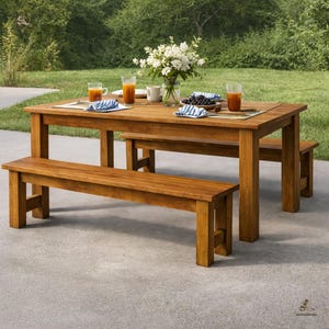 May include: A white ceramic mug with a black handle and the text "But First, Coffee" in a bold, black font. The mug is set against a blurred background, suggesting a cozy setting.