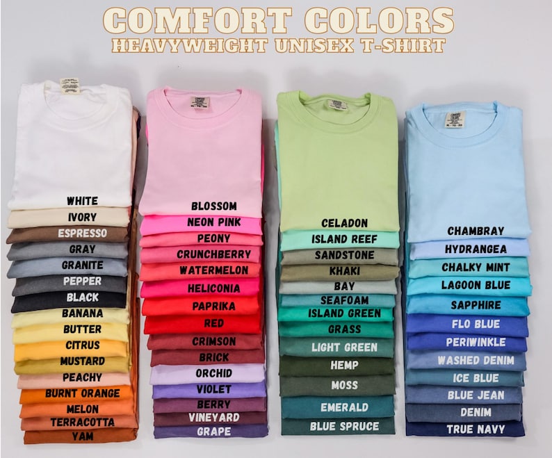 May include: Stacks of heavyweight unisex t-shirts in various colors, including white, pink, green, and blue. Each stack displays a different color with its corresponding name, such as "Blossom," "Celadon," and "Chambray."