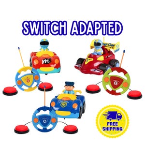 May include: Three switch-adapted remote control toy cars with drivers, each paired with a steering wheel controller and two red push-button switches. The text SWITCH ADAPTED appears at the top, and a yellow circular FREE SHIPPING badge is included.