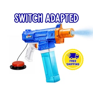 May include: A blue and orange X-Shot MotorSoaker water blaster with a clear blue water reservoir, a white handle, and a black wire connected to a round red external switch button. The text SWITCH ADAPTED is displayed above the water blaster.