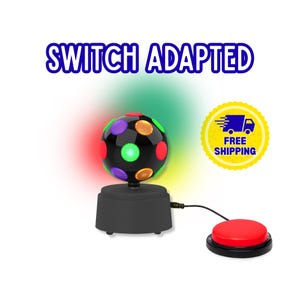 May include: A black disco ball with multicolored circular lights sits on a black base, connected by a black cord to a round red push-button switch. The text SWITCH ADAPTED appears in blue letters above the disco ball, with a yellow shipping icon.