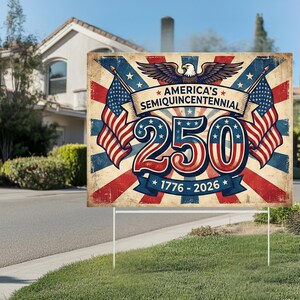 May include: A rectangular sign with the text "AMERICA'S SEMIQUINCENTENNIAL 250 1776-2026" in red, white, and blue. The sign features American flags and an eagle graphic. The sign is displayed on a lawn.
