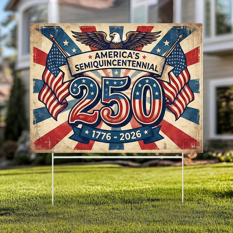 May include: A rectangular garden sign commemorating America's Semiquincentennial. The sign displays the text "America's Semiquincentennial" above the number "250" and the years "1776-2026". The design incorporates American flags, stars, and an eagle, with a vintage, distressed aesthetic.