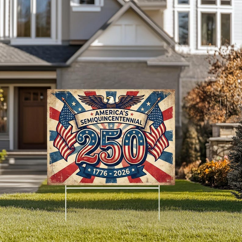May include: A rectangular garden sign commemorating America's Semiquincentennial. The sign has a vintage design with red, white, and blue colours, the number 250, American flags, and the years 1776-2026. The sign is displayed on a white metal stake.