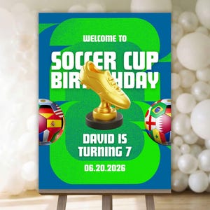 以下が含まれることがあります： サッカーをテーマにした誕生日のパーティーサイン。 金色のトロフィー、サッカーボール、そして「Welcome to Soccer Cup Birthday」というテキストが特徴です。 サインは緑と青で、「David」という名前と「7」という年齢が表示されています。