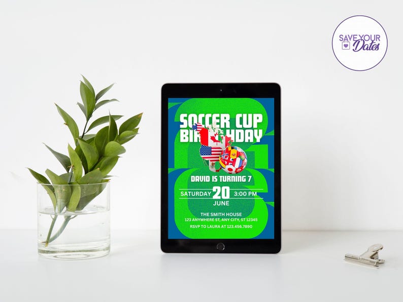May include: A digital tablet displays a soccer-themed birthday invitation. The invitation features the text "Soccer Cup Birthday" in green and blue, with flags and a soccer ball graphic. The date is June 20th, and the time is 3:00 PM.