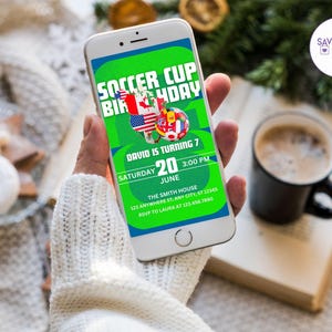 May include: A smartphone displays a soccer-themed birthday invitation. The invitation features a green background with the text "SOCCER CUP BIRTHDAY" and details for the event, including the date, time, and location. Flags of various countries are also displayed.