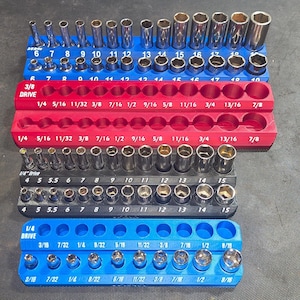 May include: A set of socket organizers in blue, red, and black, holding various sizes of sockets. The sizes are labeled in inches, ranging from 1/4 to 7/8 inch.